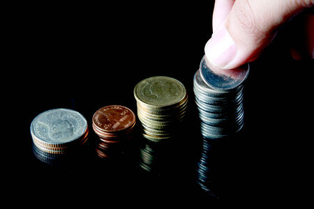 hand put coins into stack