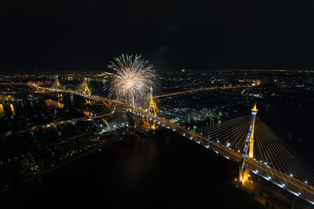 Night Scene at Bhumibol Bridge with fireworks in Bangkokの写真素材