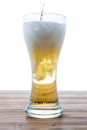 beer in a glass on white backgroundの写真素材