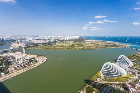 SINGAPORE - FEBRUARY 27, 2015: aerial view of Garden by the Bay and Singapore Flyer. Garden by the Bay and Singapore Flyer are the famous tourist attraction in Singapore.のeditorial素材