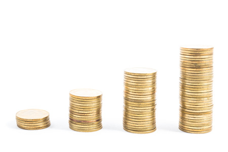 gold coin stack isolated on white backgroundの写真素材
