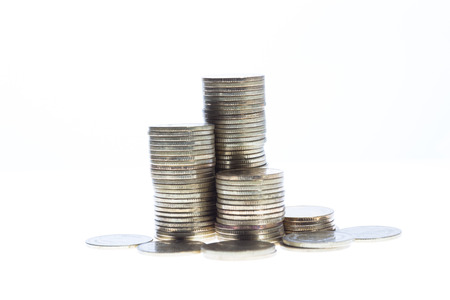 silver coin stack isolated on white backgroundの写真素材