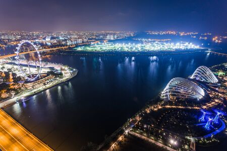 SINGAPORE - FEBRUARY 27, 2015: aerial view of Garden by the Bay and Singapore Flyer at night. Garden by the Bay and Singapore Flyer are the famous tourist attraction in Singapore.のeditorial素材
