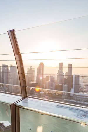 SINGAPORE - FEBRUARY 27, 2015: view from Sand sky park's hand rail with blurred sunset scene of Singapore skyline at Marina Bay, Singapore on 27 February 2015.のeditorial素材