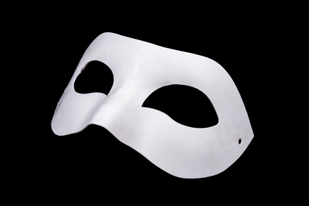 white mask isolated on black backgroundの写真素材