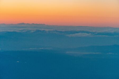 aerial of cloud and mountain in the eveningの写真素材