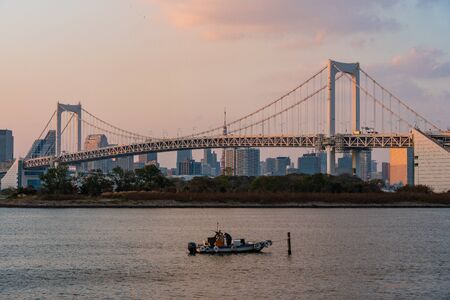 TOKYO, JAPAN - NOVEMBER 17, 2018: Sunset scene of Rainbow bridge and tokyo skyline at Odaiba, Tokyo, Japanのeditorial素材