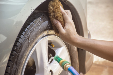 Hands and brushes for cleaning wheels carの写真素材