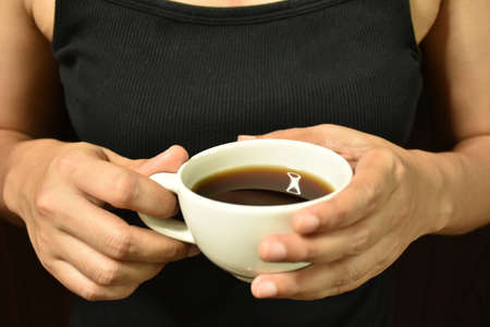Woman holding coffee cup in hand