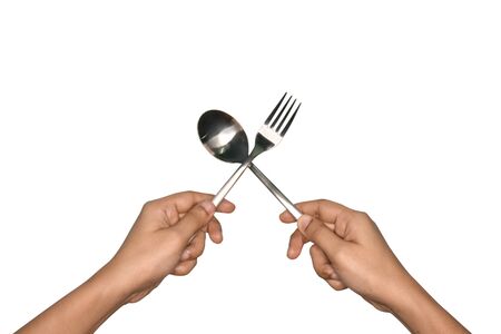 Women's hand holds spoon and fork made of aluminum.の写真素材