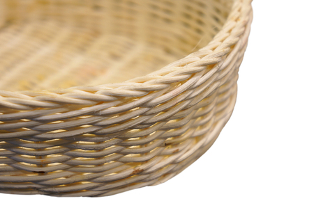 Close-up of a wicker basket on a white background. With shallow depth of field.の写真素材