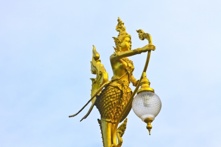 A golden Kinnari lighting pole, Thai style statueの写真素材