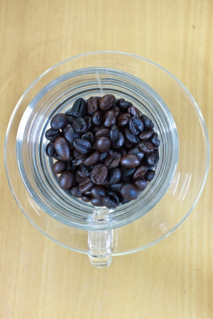 coffee beans in cup on the wood tableの写真素材