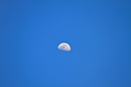 half  moon in blue sky during the dayの写真素材