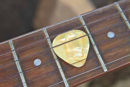 guitar pick on the fingerboard close upの写真素材