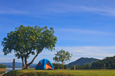 Camping in the wilderness, tent on campground in morning の写真素材