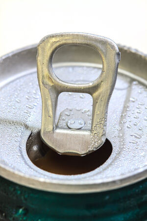 Closeup shot from the pull ring on a beverage can, opened aluminum can with water drop