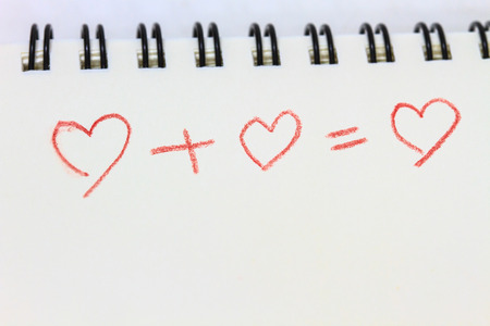 drawing heart on white notebook, love conceptの写真素材