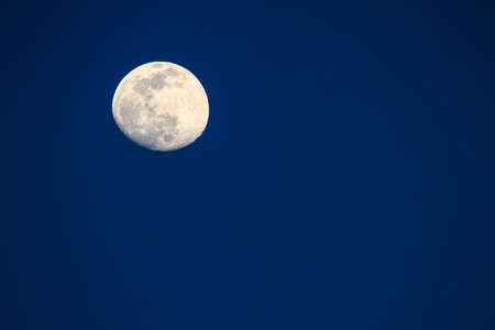 Full moon over dark sky at nightの写真素材