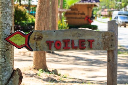 wooden toitet sign in garden park closeupの写真素材