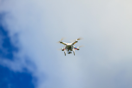 flying drone with camera on the skyの写真素材