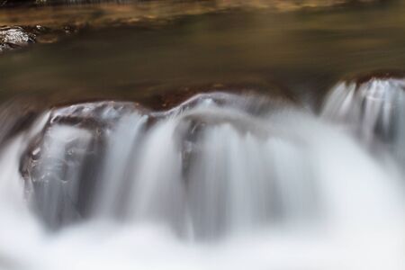 rainforest waterfall and rocks covered with mossの写真素材