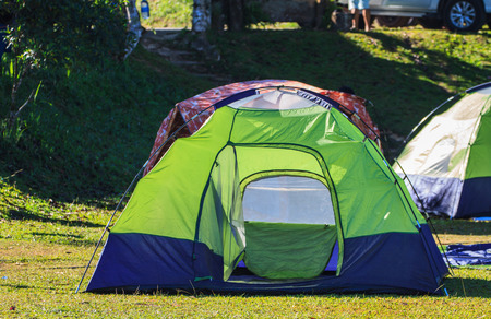 Camping in the wilderness, tent on campground in morningの写真素材
