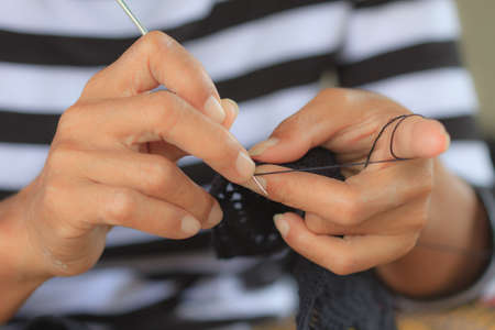 close up of hands crocheting, woman with her crochet