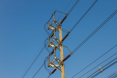 electricity pole on blue sky background in a village
