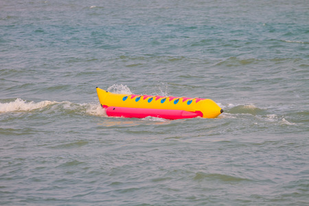 Banana Boat and wave on the beachの写真素材