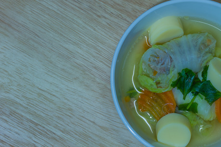 Clear soup with bean curd and minced pork on woodenの写真素材