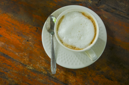 Coffee cup on a wooden table. Dark backgroundの写真素材