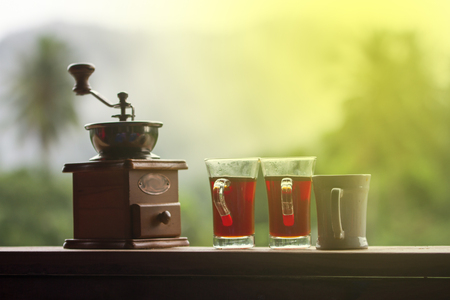 Coffee grinder with black coffee on wooden and nature backgroundの写真素材