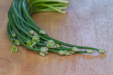 Chives flower or Chinese Chive vegetable on wooden