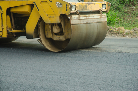 Road roller machine works on the fresh asphalt, Asphalt road construction