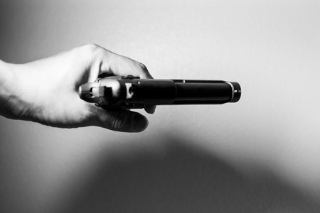 Hand holding a gunの写真素材
