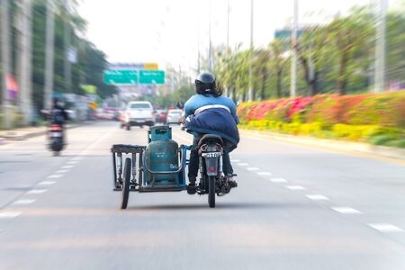 CHIANG MAI THAILAND - January 20 Unidentified The man riding old motorcycle  on the road and he has a gas tank on the motorcycle ;January 20 2015 at Chiangmai Thailandのeditorial素材