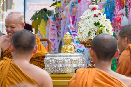CHIANG MAI ,THAILAND - APRIL 15 : The traditional Songkran festival at pour water onto Buddha image and monks. It is the gesture of worship in Songkran festival at Watphadarabhirom a famous temple on April 15, 2015 in Chiangmai,Thailand.のeditorial素材