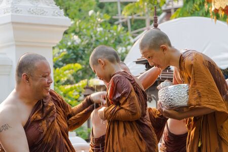 CHIANG MAI ,THAILAND - APRIL 15 : The traditional Songkran festival at pour water onto Buddha image and monks. at Watphadarabhirom a famous temple on April 15, 2015 in Chiangmai,Thailand.のeditorial素材