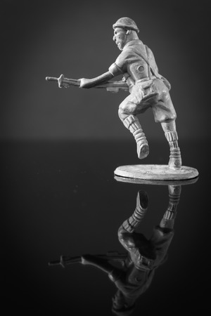 Closeup of action mini toy soldier on black backgroundの写真素材
