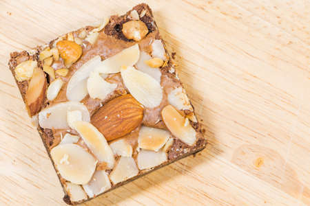 Homemade brownies sliced and  topping on  wooden backgroundの写真素材