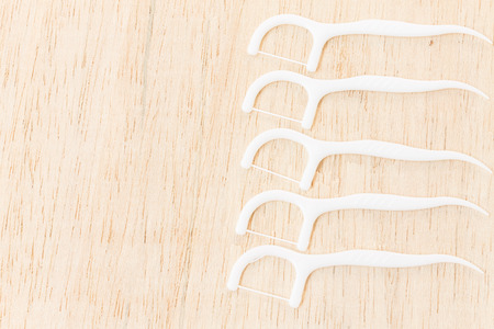 Oral Device : Dental floss on wooden background