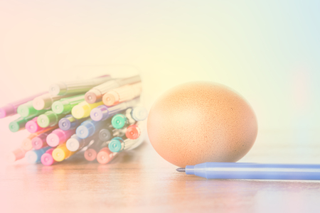Easter Egg Chickens and color pen on wooden tableの写真素材