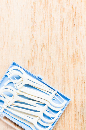 Oral Device : White dental flossers on wooden backgroundの写真素材
