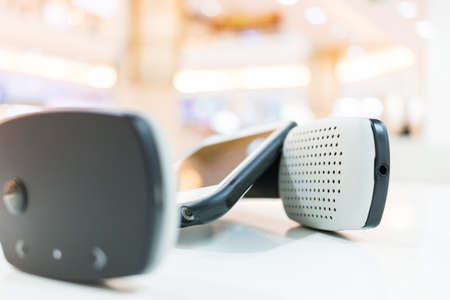 Wireless headphones and cellphone with bokeh background
