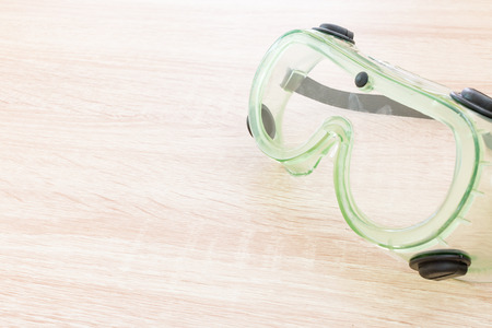 Industrial Protective Workwear.  Safety glasses on wooden backgroundの写真素材