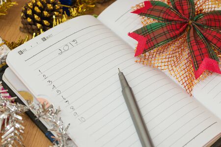 Notebook on a wooden table with new year goals 2017の写真素材