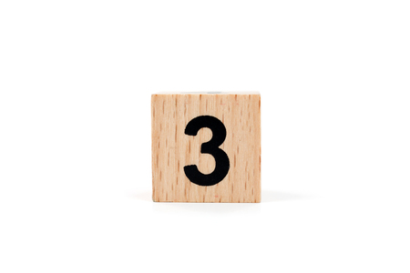 Wooden block Number three on white background