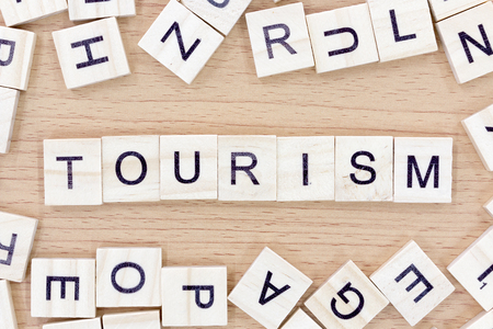 Tourism words with wooden blocks on wooden floorの写真素材