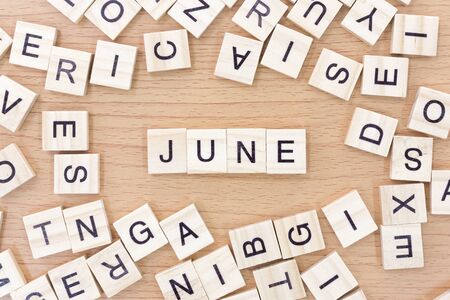 June words with wooden blocks on wooden floor